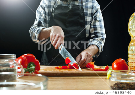 Preparing salad. Female chef cutting fresh vegetables. Cooking process. Selective focus Preparing salad. Female chef cutting fresh vegetables. Cooking process. Selective focus 46398440