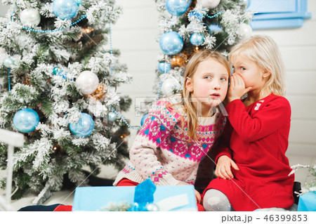 Happy little kids opening presents on Christmas eve Happy little kids opening presents on Christmas eve 46399853