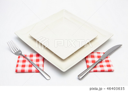 White square plate on the white wooden table. 46403635