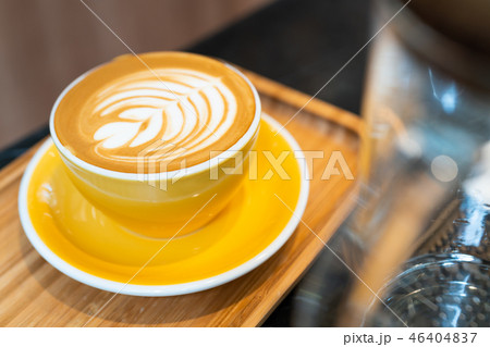 Latte art coffee cup in yellow glass 46404837