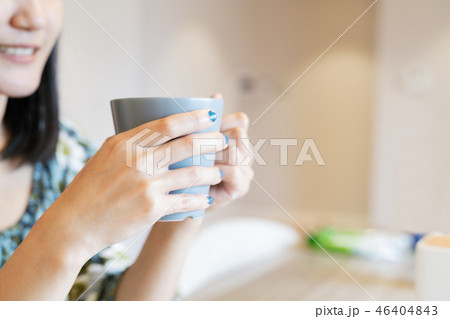hands holding hot cup of coffee in morning 46404843
