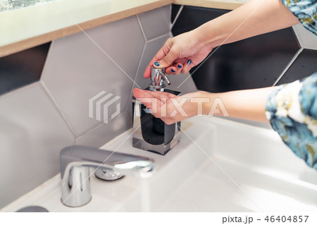 women washing hand with liquid soap in restroom women washing hand with liquid soap in restroom 46404857