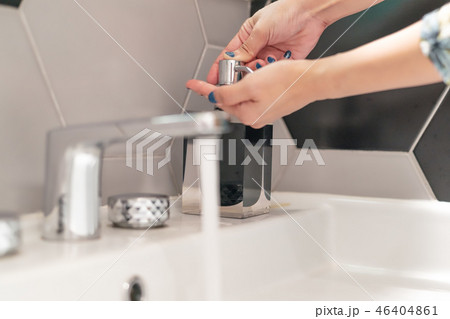 women washing hand with liquid soap in restroom women washing hand with liquid soap in restroom 46404861
