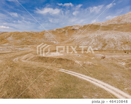 Dirt road in remote Bosnia steppe Dirt road in remote Bosnia steppe 46410848