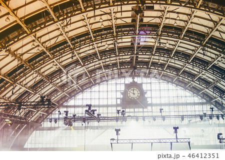 Vintage clock in front of old industrial interior Vintage clock in front of old industrial interior 46412351