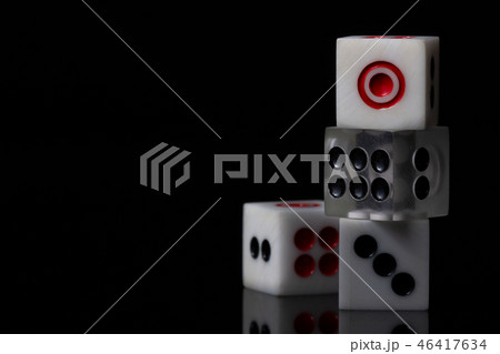 Closeup three dice stacked on dark background. Closeup three dice stacked on dark background. 46417634