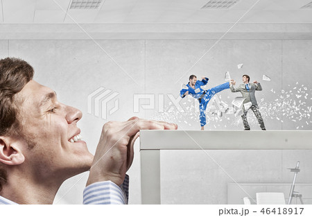 Businessman peeping from under table 46418917