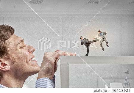 Businessman peeping from under table Businessman peeping from under table 46418922