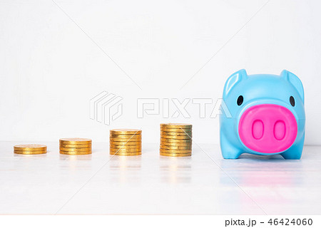 Blue piggy bank with piles of golden coins Blue piggy bank with piles of golden coins 46424060