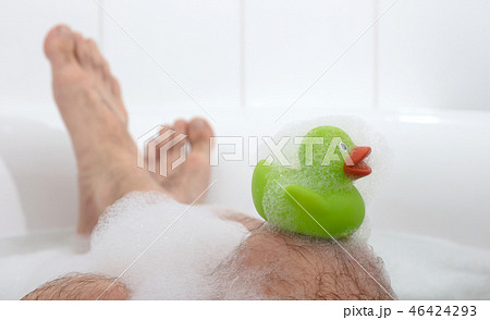 Men's feet in a bathtub, selective focus on toes 46424293