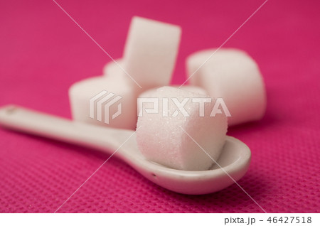 sugar in shaped circle in white spoon sugar in shaped circle in white spoon 46427518