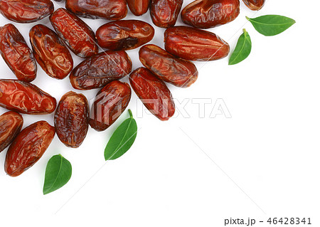 dry dates with green leaves isolated on white background with copy space for your text. Top view dry dates with green leaves isolated on white background with copy space for your text. Top view 46428341