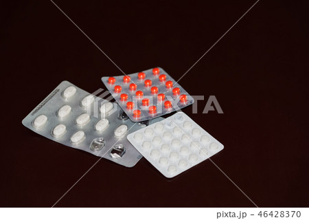 Pills in blister packaging on dark background Pills in blister packaging on dark background 46428370