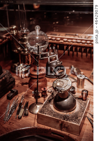 Old antique clockmaker table with tools 46429079