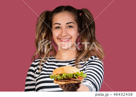 Cool girl with ponytails showing the hamburger  46432438