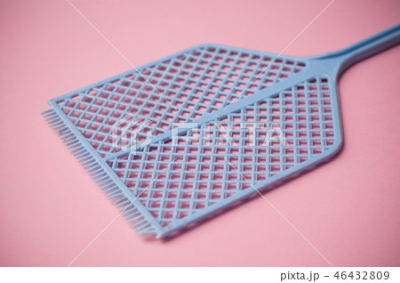 closeup of blue fly swatter on pink background closeup of blue fly swatter on pink background 46432809