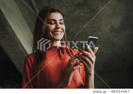 Smiling business woman reading messages on phone 46434467