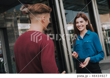 Friendly male and female colleagues meet on street Friendly male and female colleagues meet on street 46434927
