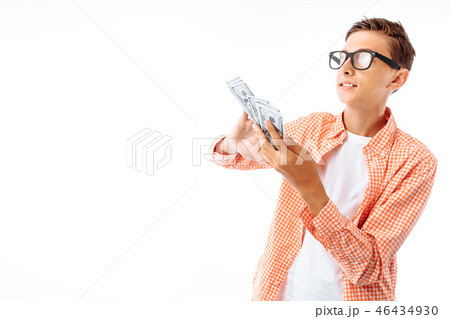 A young man with glasses throws a hundred dollars  46434930