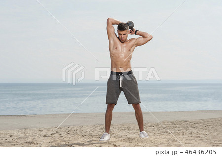 Portrait of young strong man training with kettle bell. Portrait of young strong man training with kettle bell. 46436205