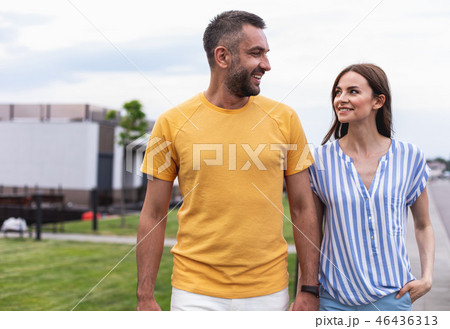 Cheerful smiling couple walking down the street Cheerful smiling couple walking down the street 46436313