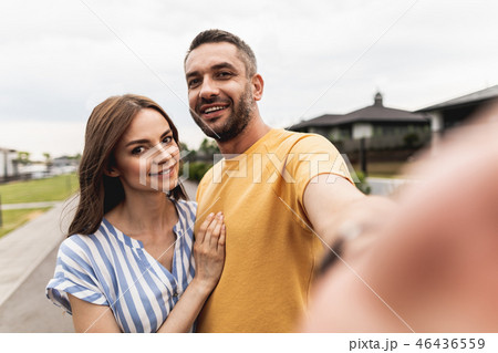 Blithesome embracing couple making photo together outdoors Blithesome embracing couple making photo together outdoors 46436559