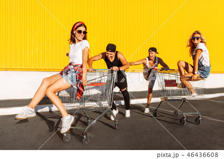 Friends ride on carts, near the supermarket 46436608