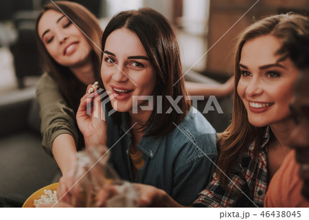 Cheerful girls enjoying snacks while spending time at home 46438045