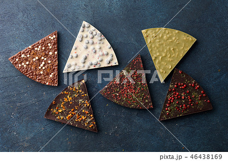 Chocolate triangle pieces on blue background 46438169
