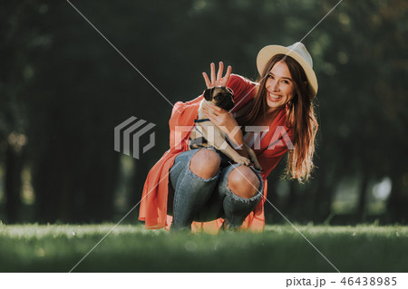 Happy lady is holding her dog on hands Happy lady is holding her dog on hands 46438985