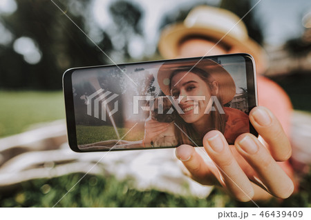 Young woman is making selfie by phohe with her dog Young woman is making selfie by phohe with her dog 46439409
