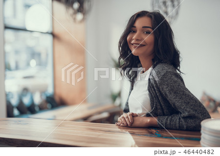 Cheerful lady putting hands on the bar counter and smiling 46440482