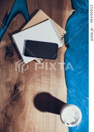 Top view of stylish table with modern smartphone and coffee on it Top view of stylish table with modern smartphone and coffee on it 46440915