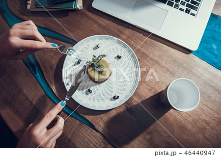 Woman hands holding knife and fork while cutting the cake Woman hands holding knife and fork while cutting the cake 46440947