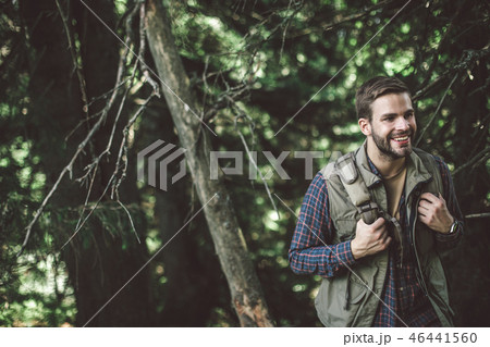Traveler man walking on green trees forest Traveler man walking on green trees forest 46441560