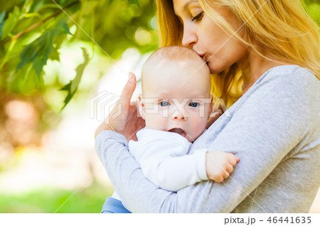 Close up portrait of mother kissing her infant baby Close up portrait of mother kissing her infant baby 46441635
