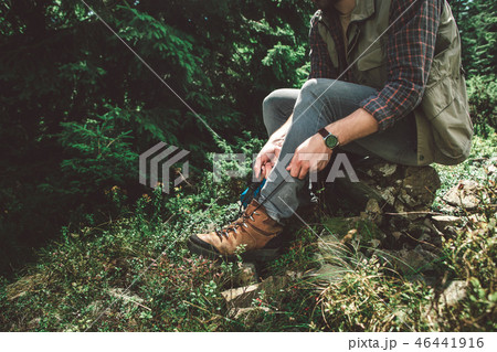 Traveler man taking break on green mountain hill 46441916