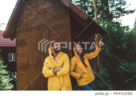 Traveler couple enjoying journey in rainy weather Traveler couple enjoying journey in rainy weather 46442086