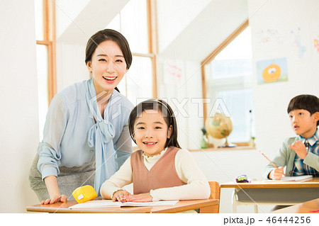 Young Students In Math Class With A Female Teacher Young Students In Math Class With A Female Teacher 46444256