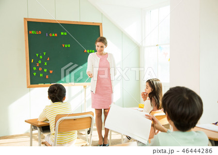 Female Teacher Teaching English To Young Students Female Teacher Teaching English To Young Students 46444286