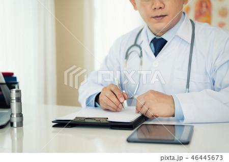 Doctor writing on medical health care record 46445673