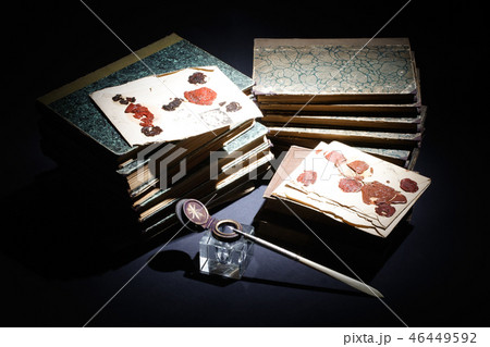 old books, papers, ink pen and inkpot on black  46449592