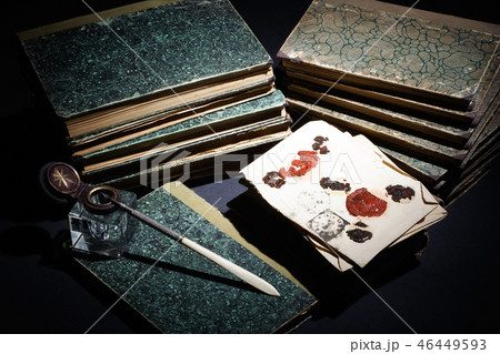 old books, papers, ink pen and inkpot on black  46449593