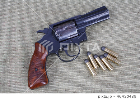 Revolver with ammunition on the canvas background 46450439