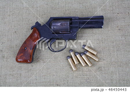 Revolver with ammunition on the canvas background 46450443