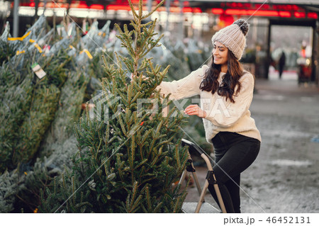 Cute brunette in a white sweater with Christmas tree 46452131