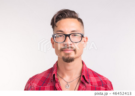 Young handsome man in checkered shirt and glasses smiling in white background 46452413
