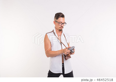 Technologies, photographing and people concept - handsome young man with retro camera over white 46452518
