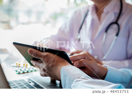 Patient listening intently to a male doctor 46453753