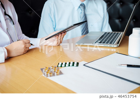 Patient listening intently to a male doctor 46453754